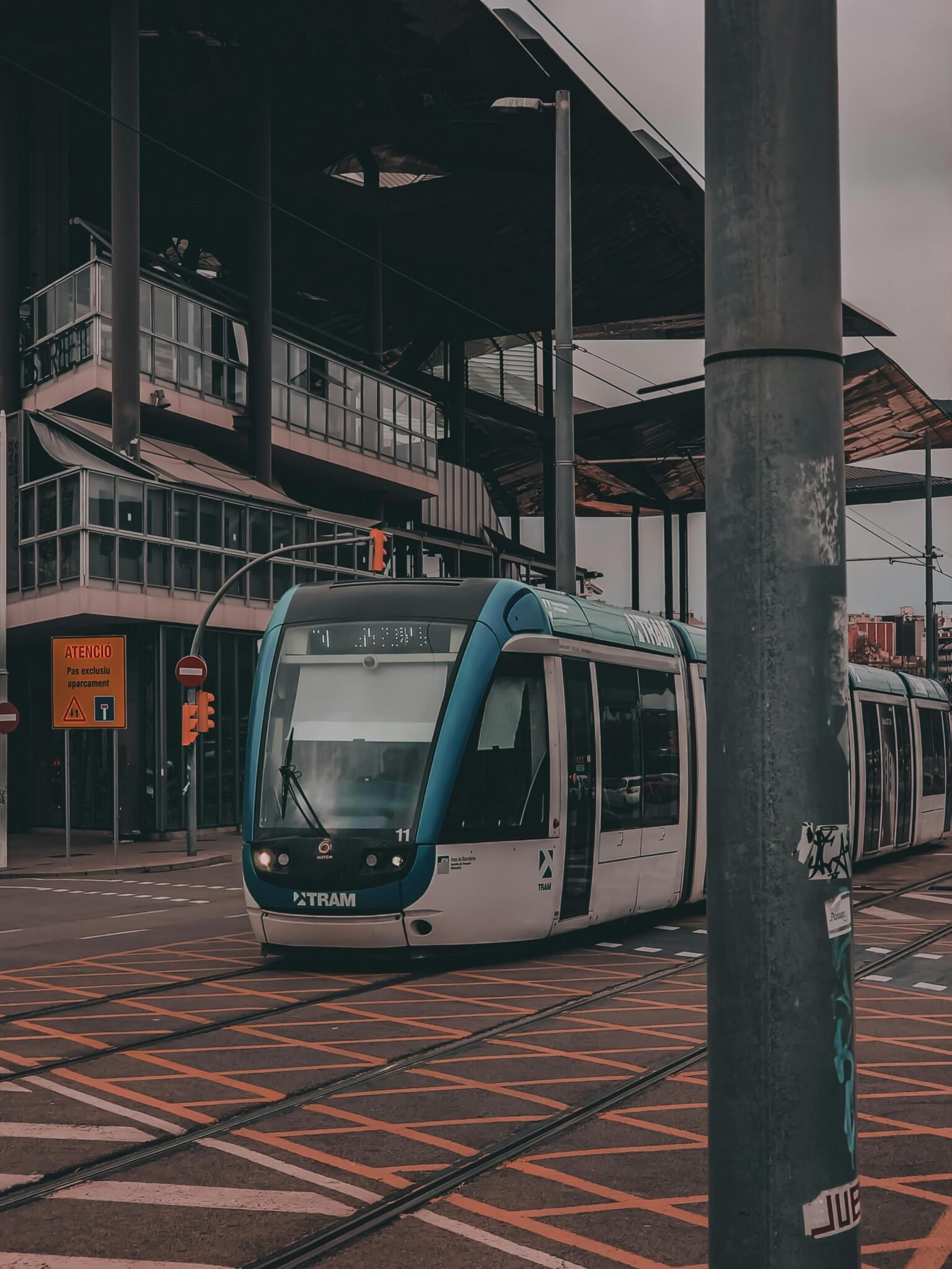 Urban scene depicting a modern tram on the bustling streets of Barcelona, Spain.